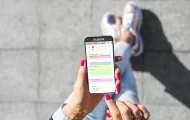 woman walking looking down at her phone