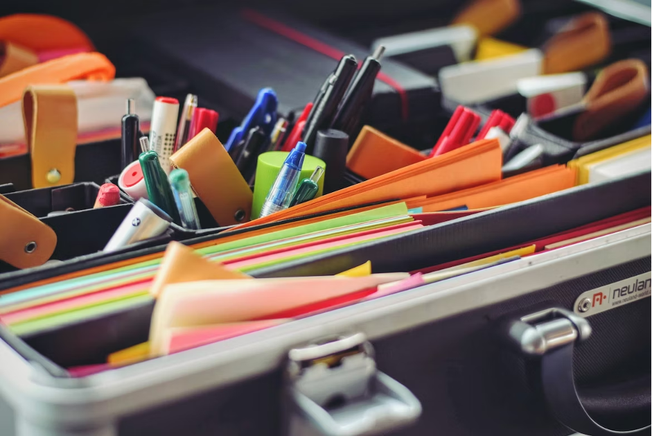 a portfolio filled with pens, stickie notes and documents