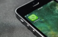 Picture of a phone with a WhatsApp icon.