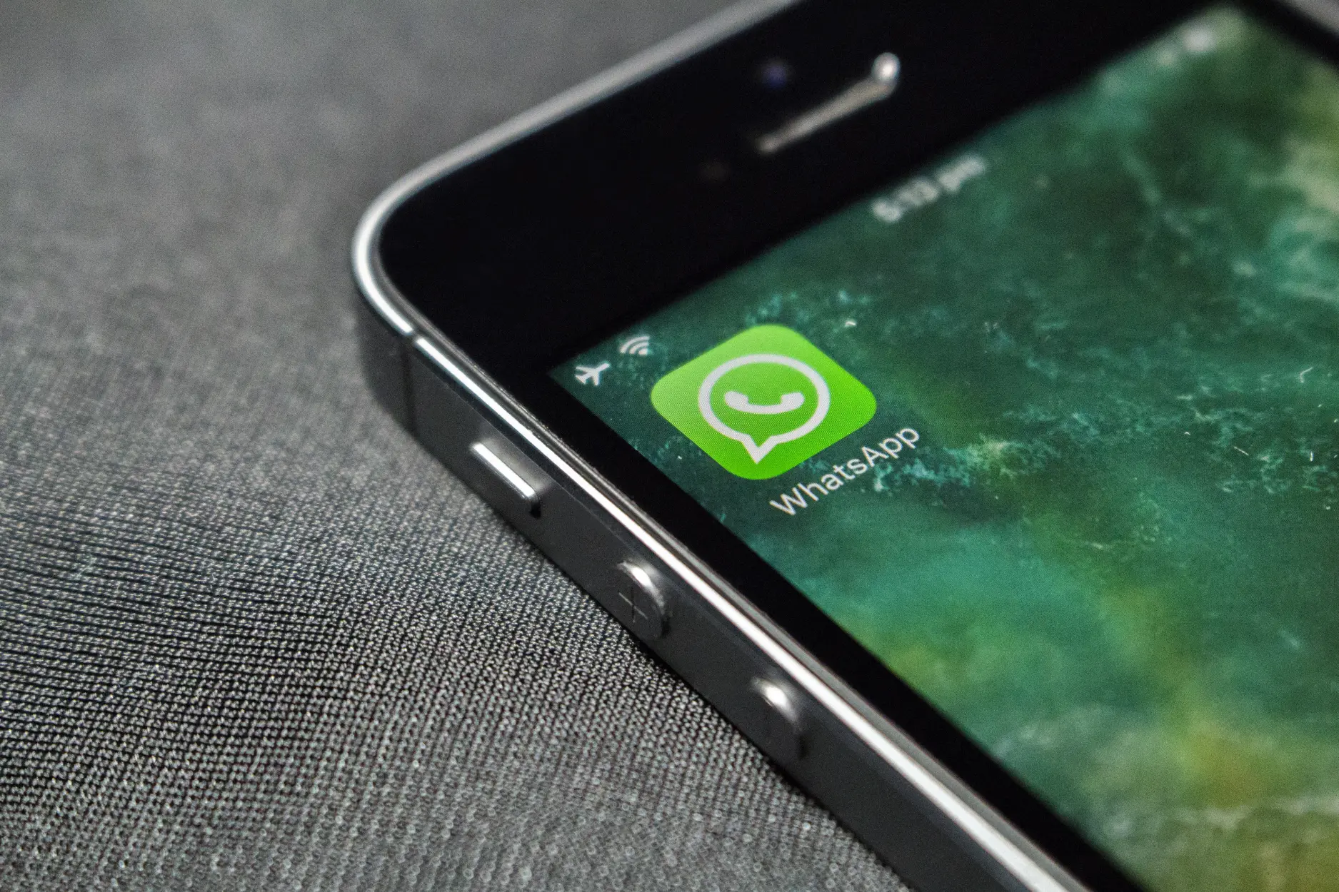 Picture of a phone with a WhatsApp icon.