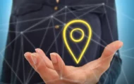 Man's open hand with a localisation icon hovering above it.