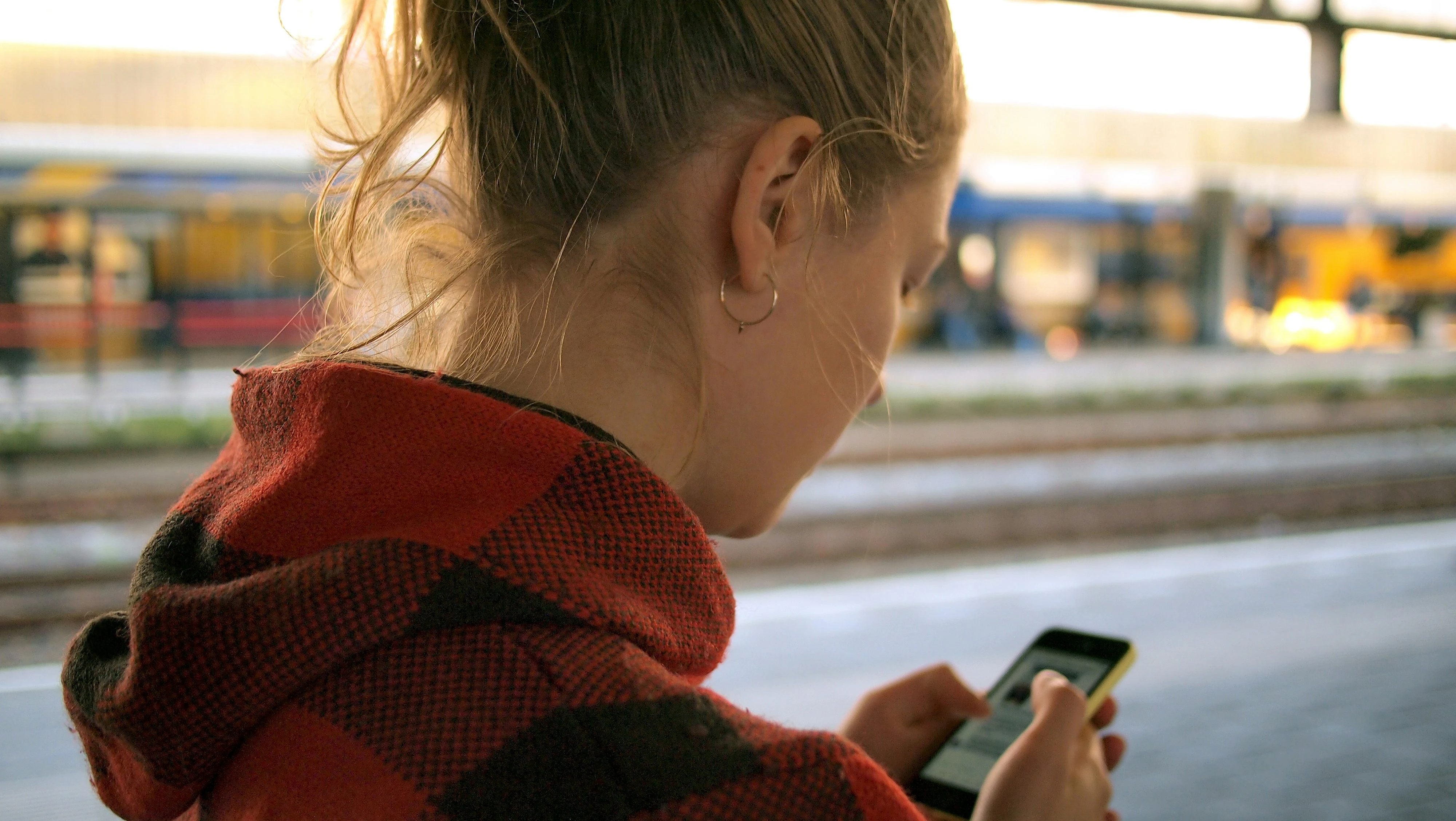 A woman holding an android phone.