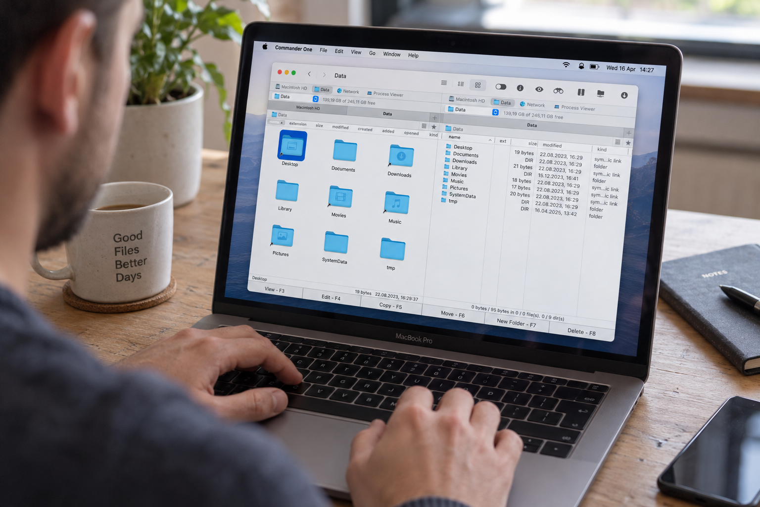 Person using a laptop with a file management application open on the screen at a desk.