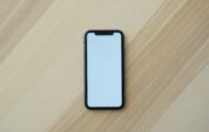 A picture of a mobile phone on a wooden background